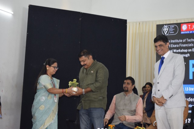 A guest receives a sapling as a token of appreciation from the host institution