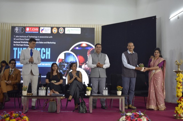 Guests honoured on stage in front of the workshop banner