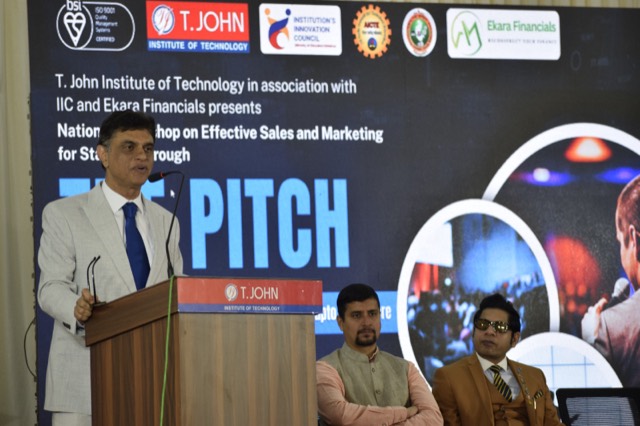 A keynote speaker addresses the workshop from the podium