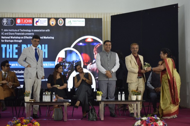Felicitation of a guest as dignitaries look on