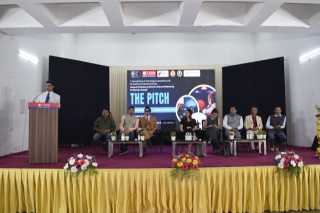 Speaker at the podium with the full panel seated on stage