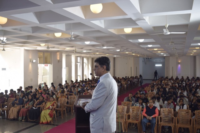 A speaker engages directly with the student audience